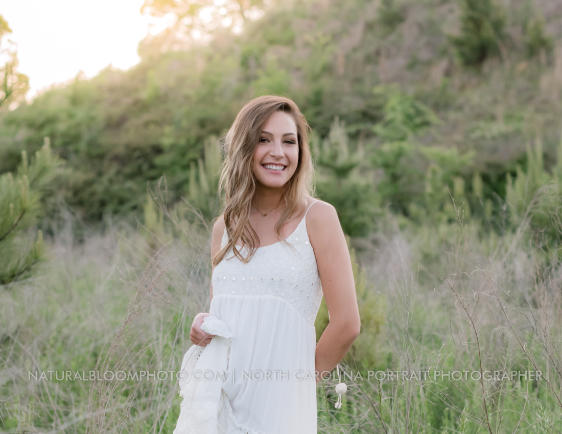 Waxhaw NC High School Senior Pictures in field at sunset